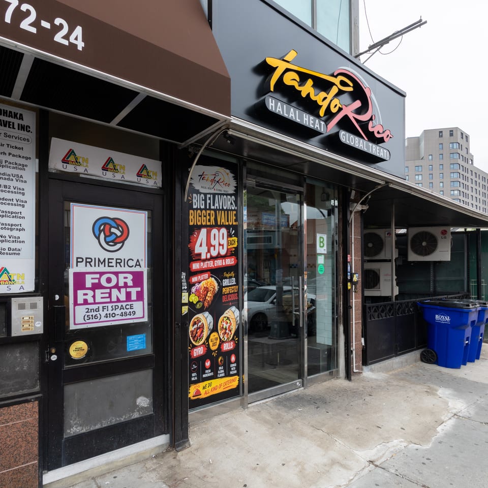 Exterior of Tandoorico restaurant with a "Big Flavors, Bigger Value" sign and menu items.