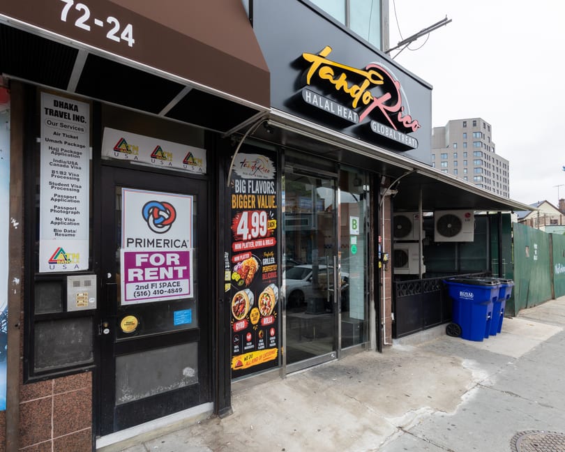 Exterior of Tandoorico restaurant with a "Big Flavors, Bigger Value" sign and menu items.