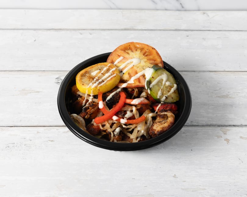 Grilled chicken, onions, and peppers topped with lemon, tomato, zucchini, and white sauce.